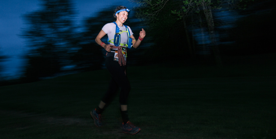 a ragnar trail running relay participant running at night