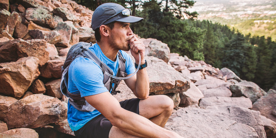 a hiker taking a hydration break on the trail