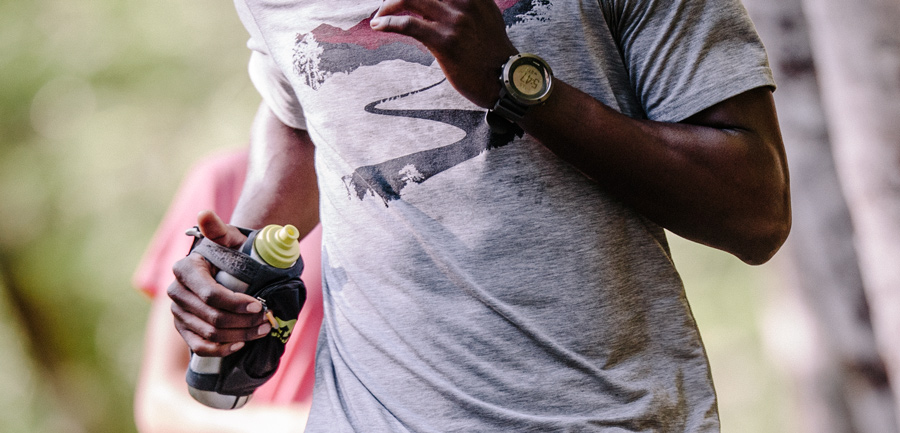 trail runner with handheld water bottle in hand