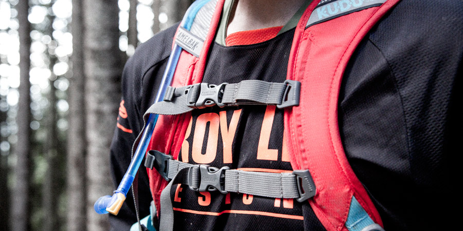 the shoulder and sternum straps of a hydration pack