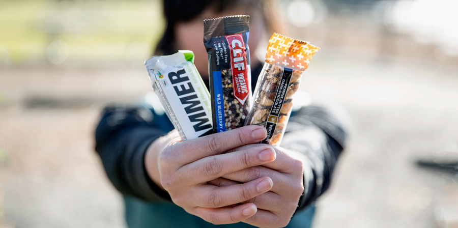 a trail runner displaying three edible bar options