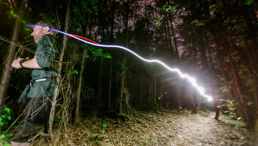 a trail runner on the trail at night