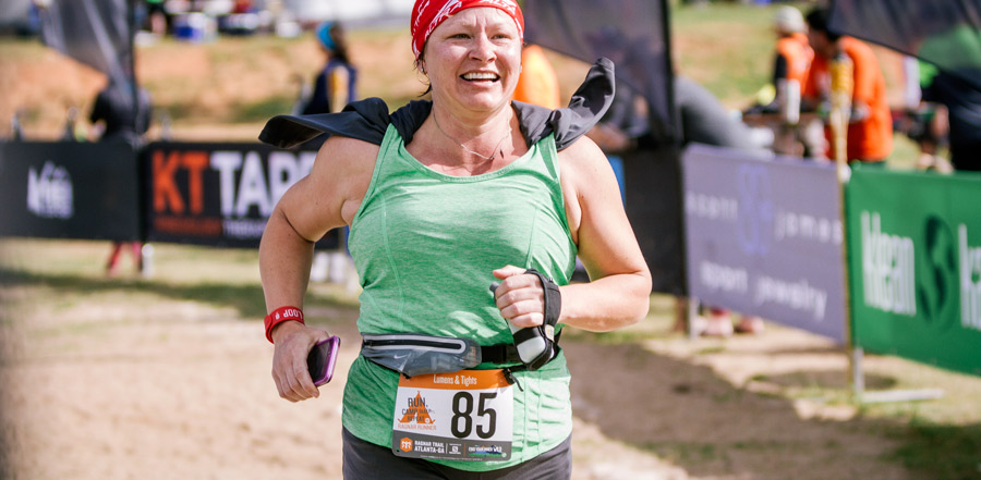 trail runner nearing the finish line at a trail running race event