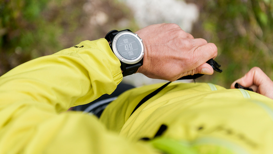 trail runner looking at their fitness watch