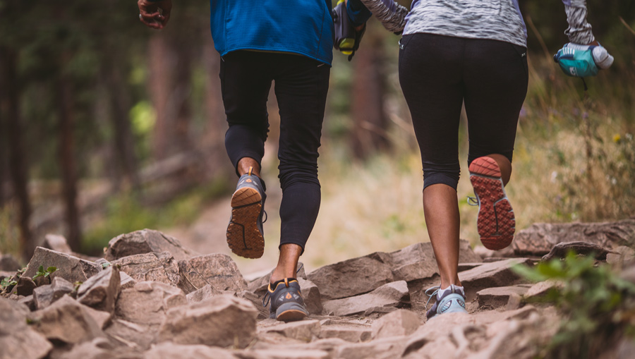 two train runners running on an uphill trail