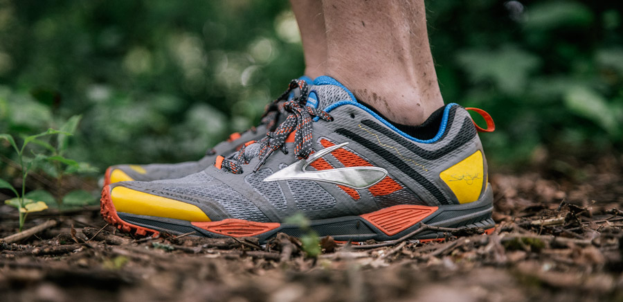 a close up of a trail runner's shoes