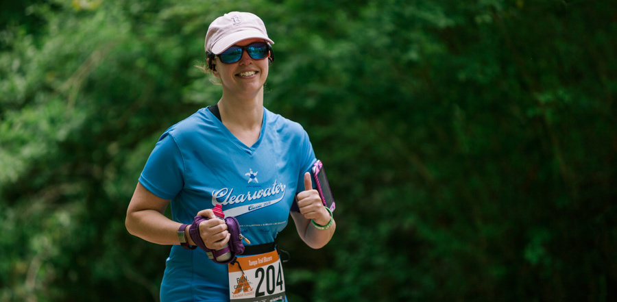a happy trail running race participant giving the thumbs up