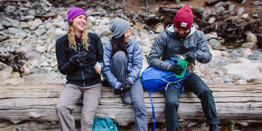 a group of happy hikers taking a water break