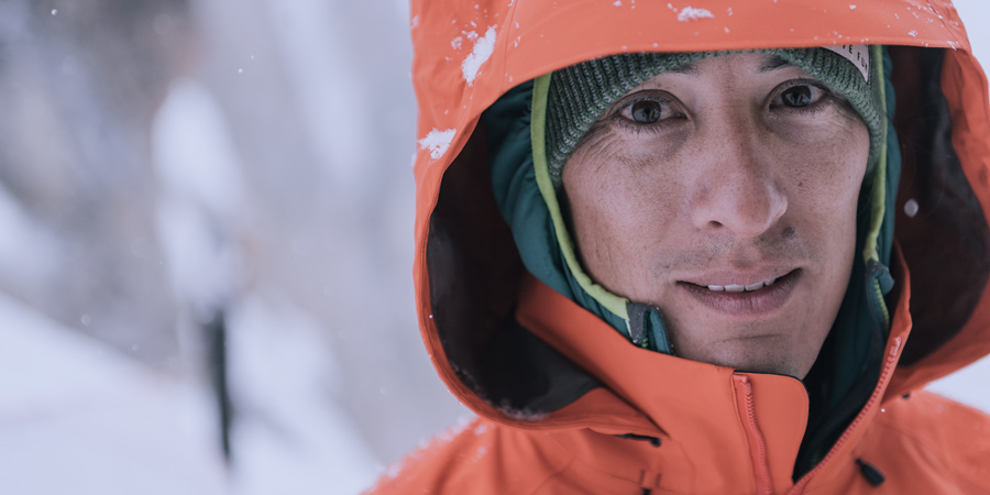 portrait of a hiker bundled up on a cold day on the trail