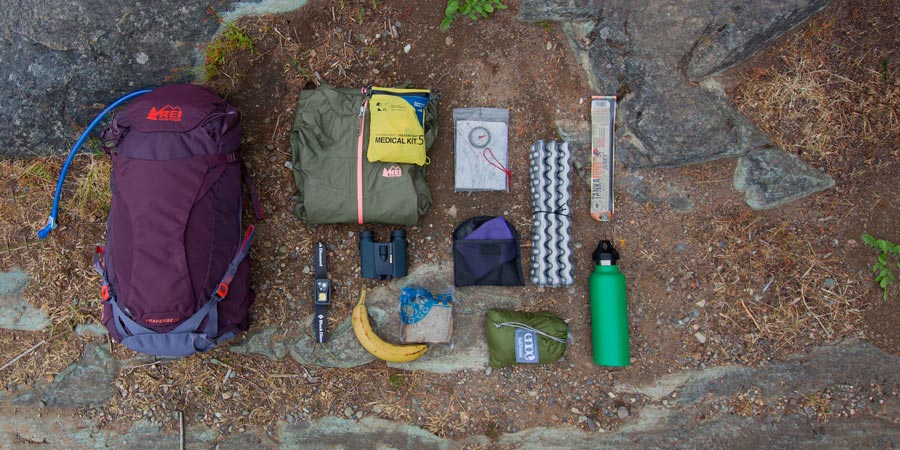 an assortment of gear that could fit into a daypack with a gear capacity between 21-35 liters