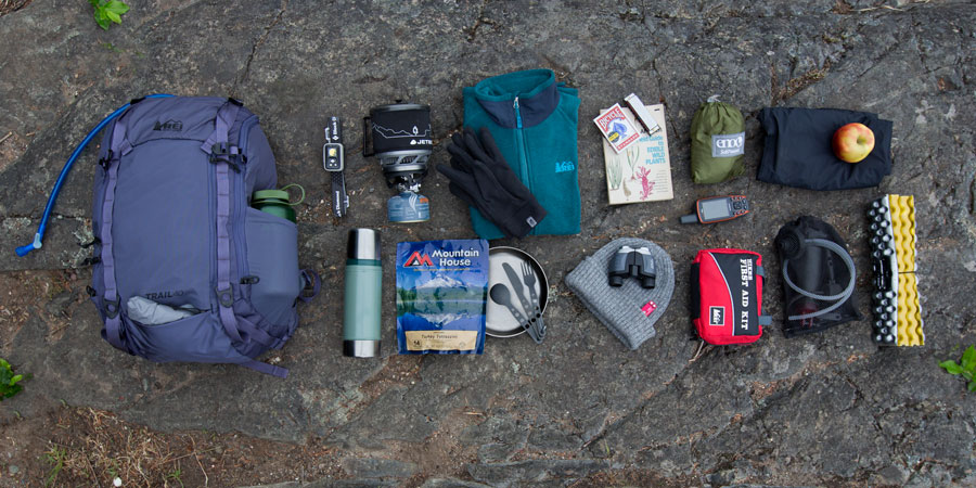 an array of gear that would fit into a daypack with gear capacity of 36-50 liters