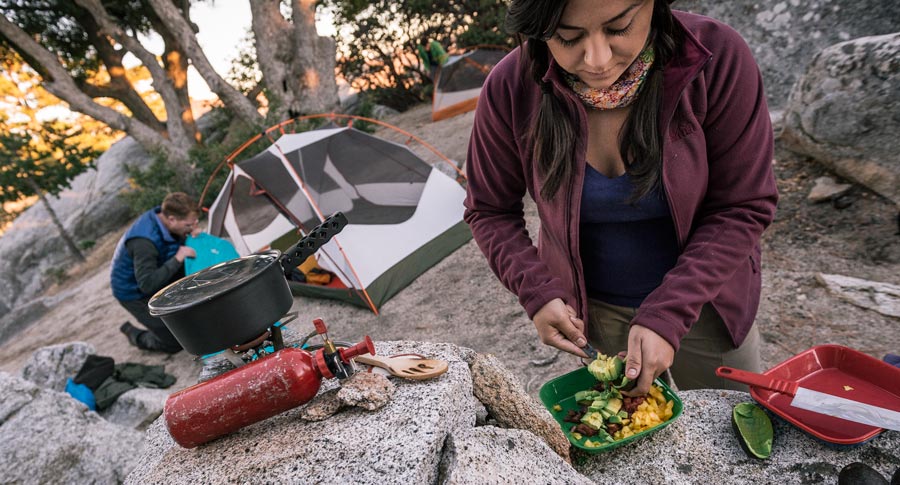 camper preparing a meal at camp