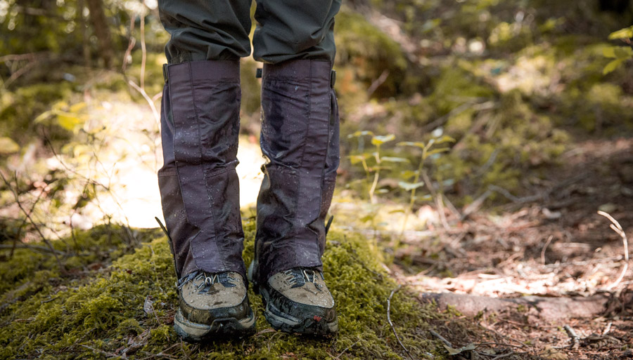 a hiker wearing gaiters in wet conditions